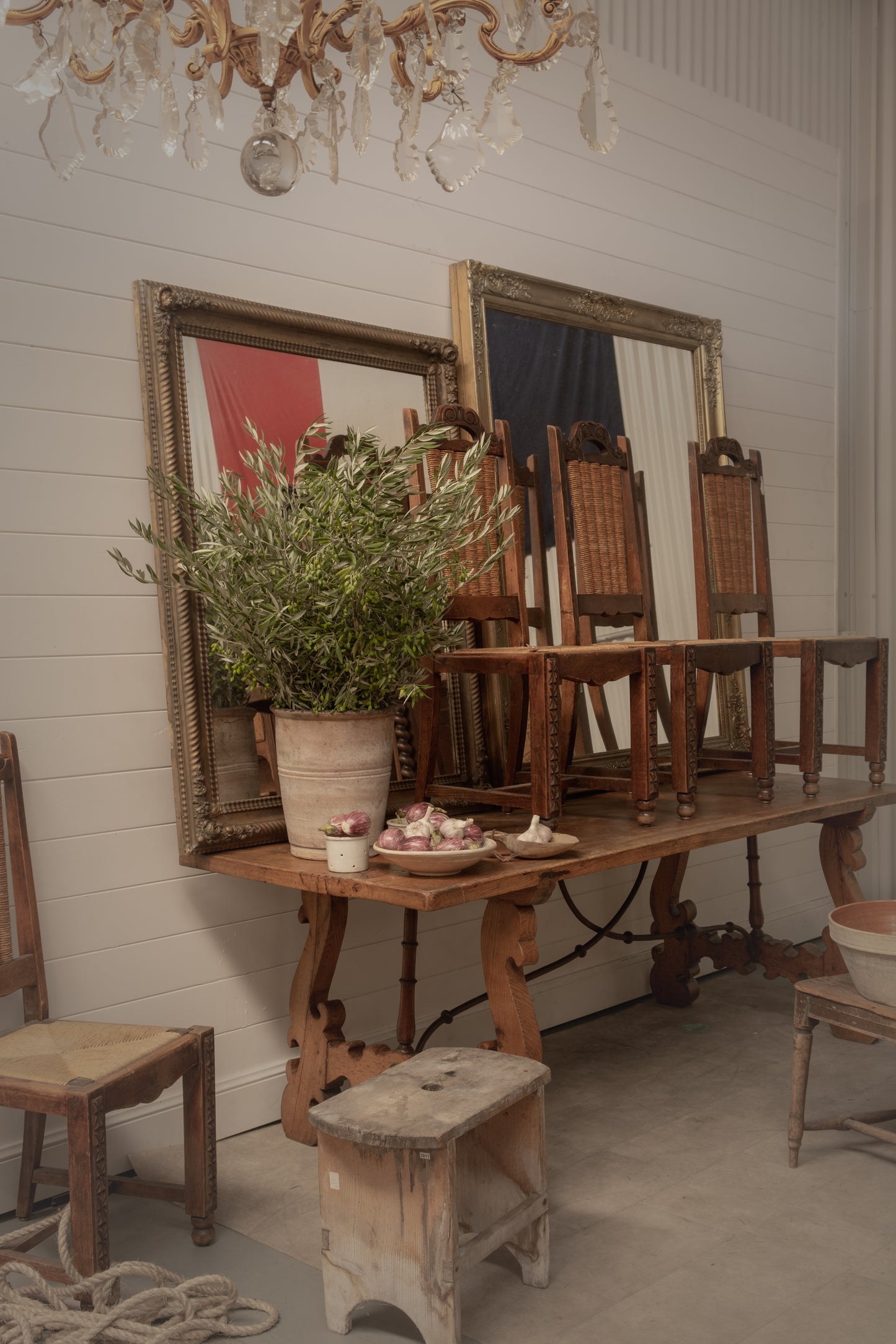 Set of 4 Antique French ladder-back dining chairs with wicker seats and black rest and intricate carvings on the frame from the French Alps