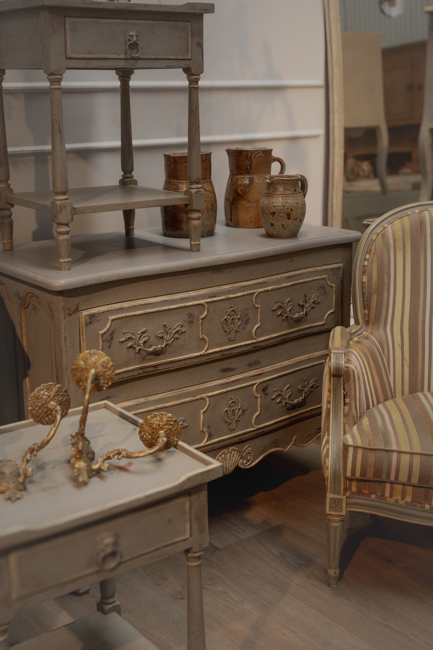 Antique French Louis XV style commode with a lovely time worn grey patina and hand carved coquille shell carvings and raised panel drawer fronts from Provence