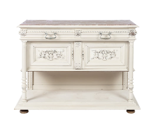 A lovely Antique French marble top console table in a cream paint featuring a lower shelf and two generous storage drawers. Cracked marble.