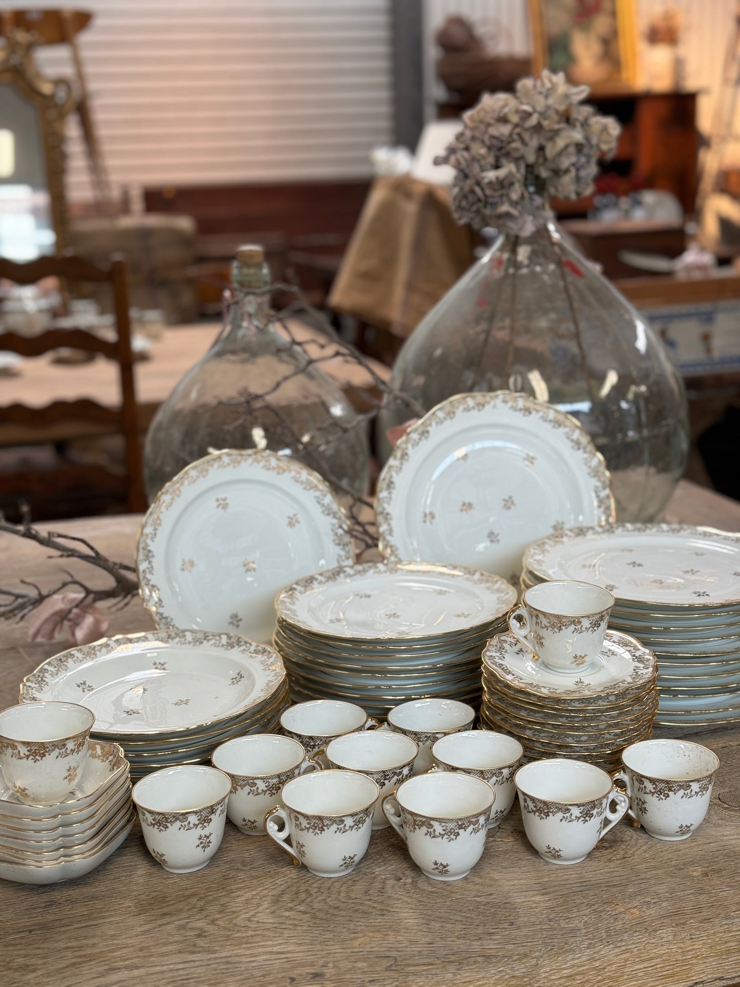 Antique French 'Limoges' 49-piece dinner set with beautiful floral and lace gold leaf design with gold painted edges.