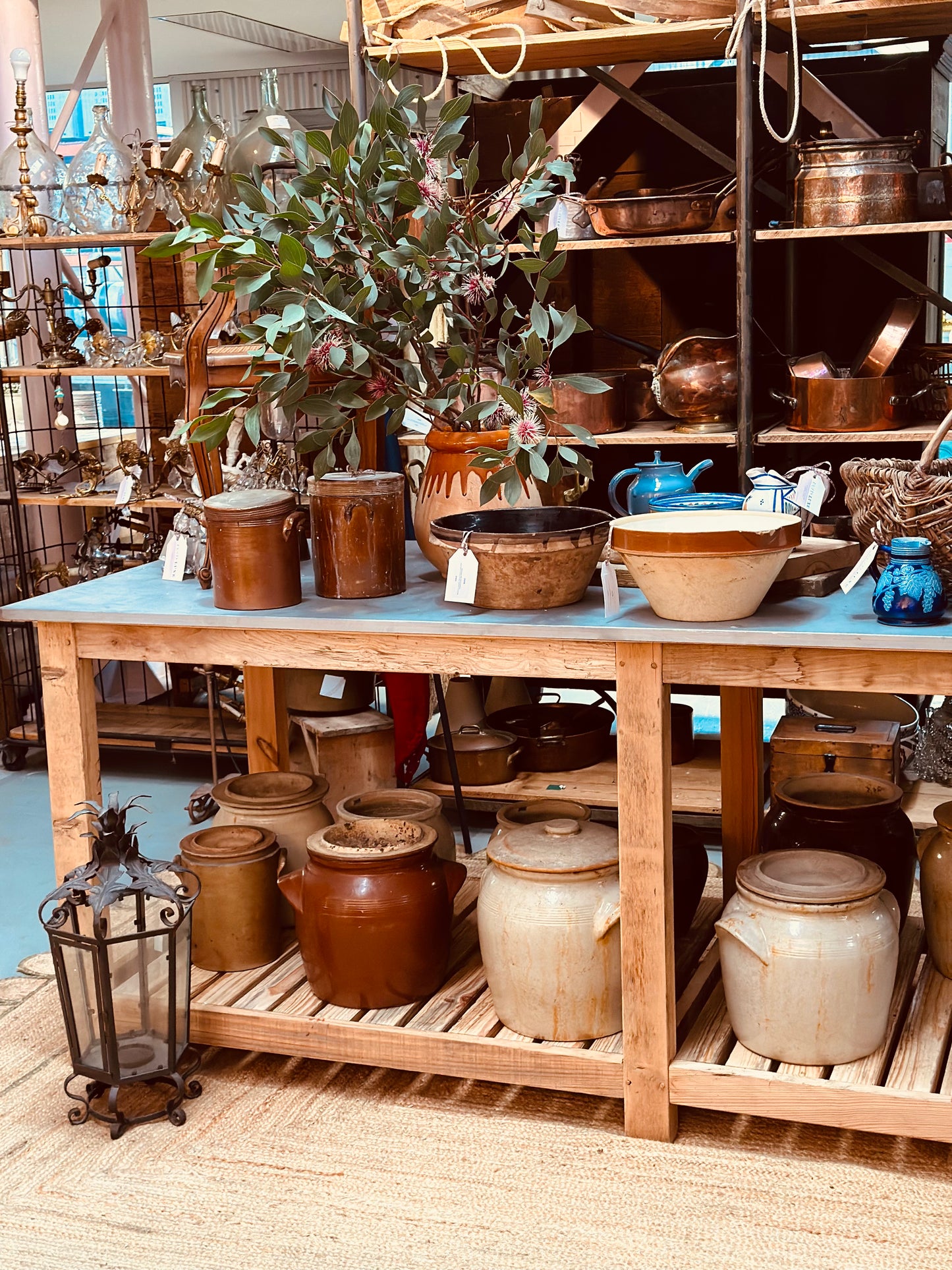 An impressively high kitchen island/work bench with zinc top made by a local timber craftsman in the French Alps from reclaimed antique French oak.