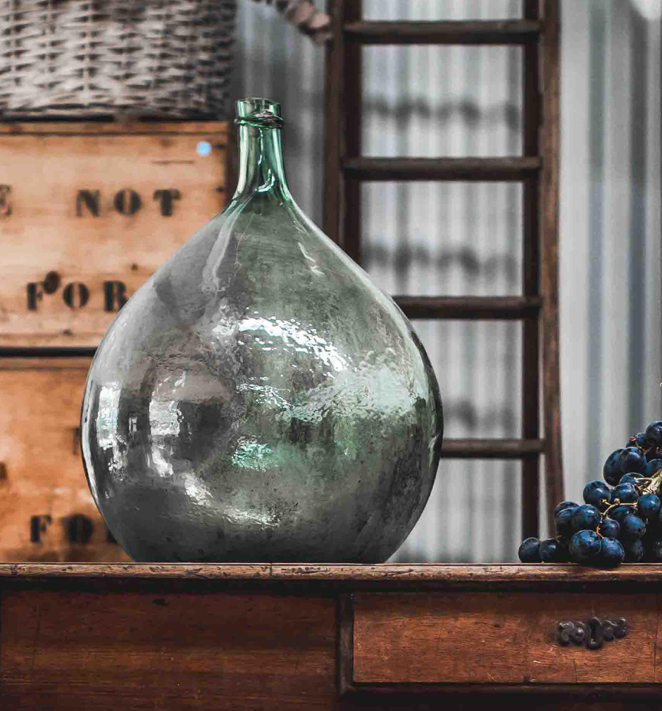 A gorgeous large green demijohn blown glass wine makers bottle, from Provence