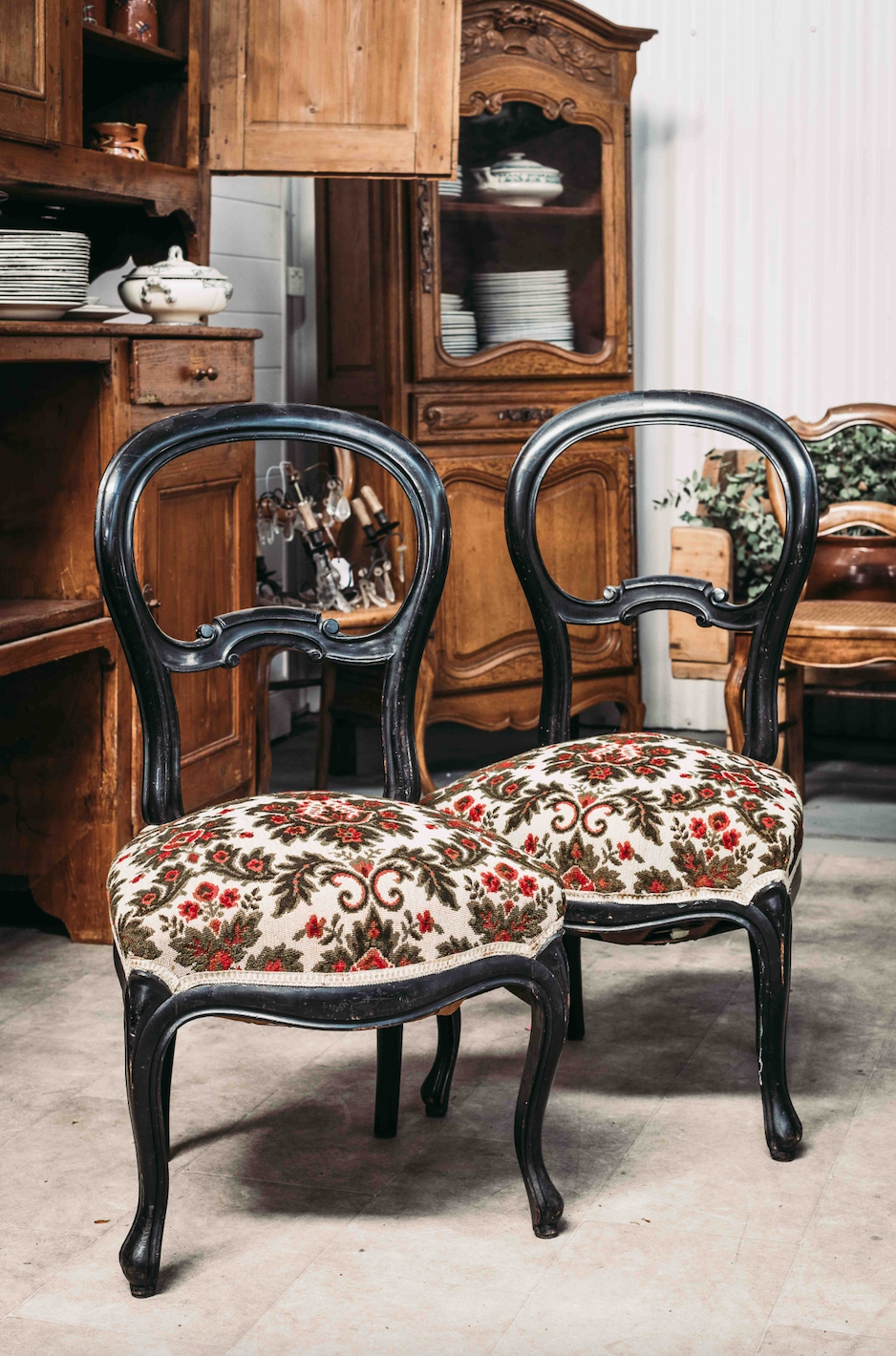 A pair of lovely black timber salon chairs with upholstered seats, from the French Alps