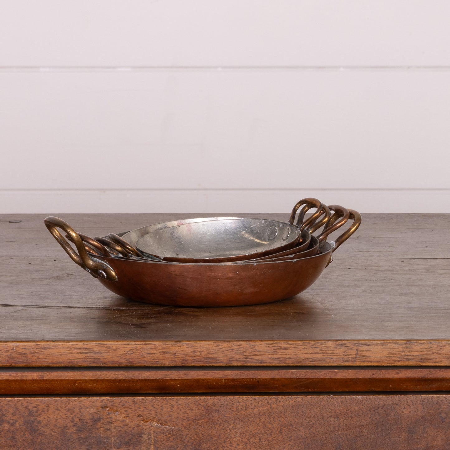 Set of 4 stackable shallow copper serving pans with brass handles from Provence