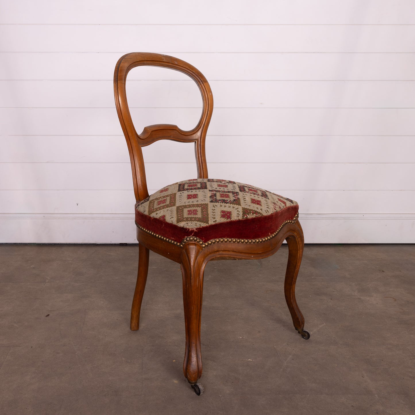 Lovely Vintage French Walnut salon chair with cross-stitch upholstery and small castors