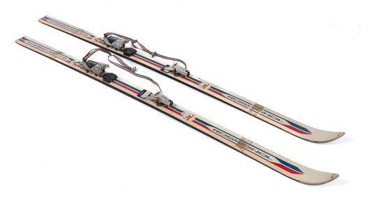 A retro pair of French skis - red Rossignol with original bindings. Discovered in The French Alps