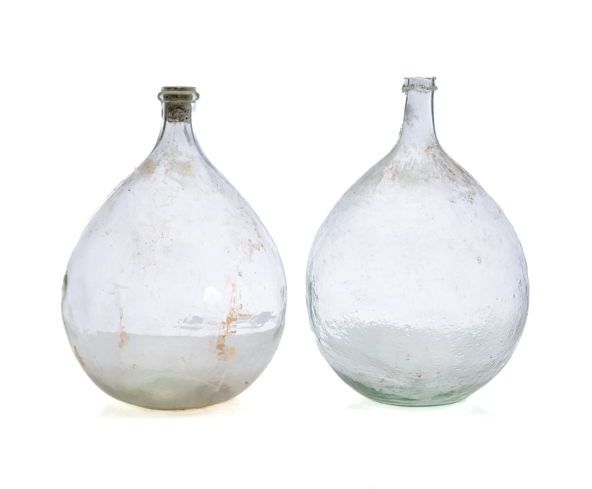 A pair of large vintage clear demijohn glass wine bottles from Bonnieux in Provence