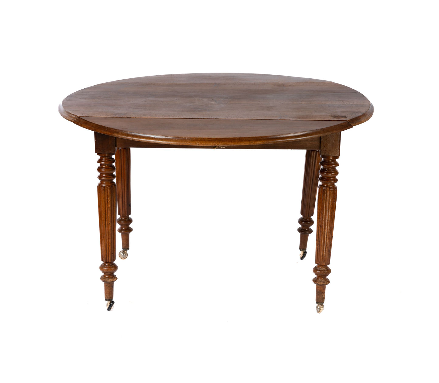 19th Century antique French walnut round table with fold down sides and turned legs on castors.