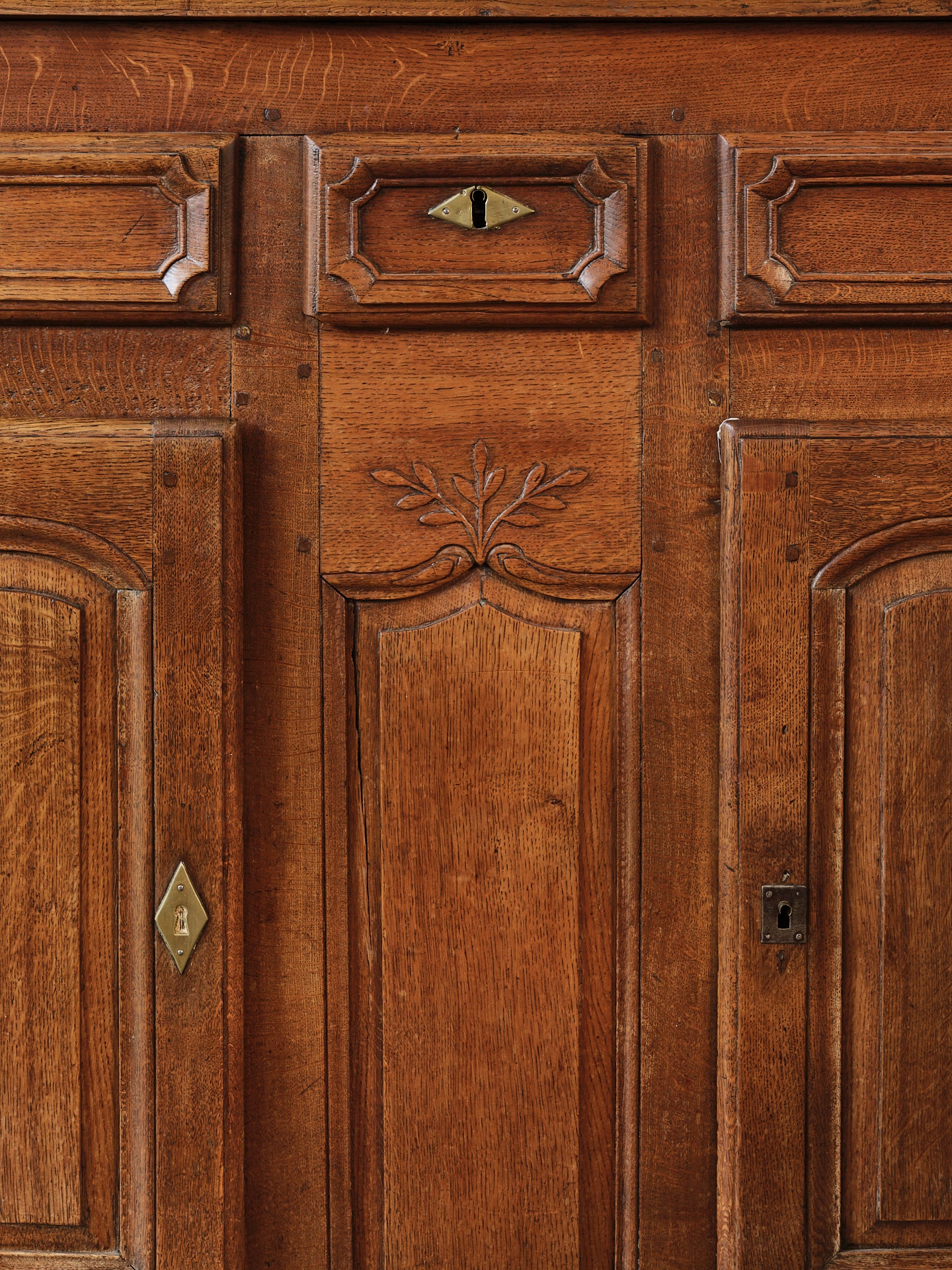 A charming 19th century antique French oak sideboard with brass hardware and some lovely timber carvings found in a grocery shop, in the French Alps.