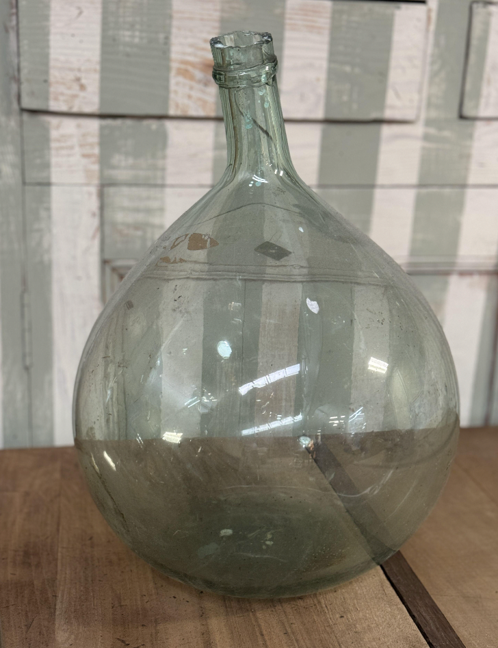 A gorgeous large green demijohn blown glass wine makers bottle, from Provence