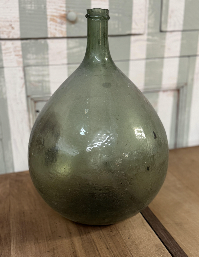 A gorgeous large green demijohn blown glass wine makers bottle, from Provence