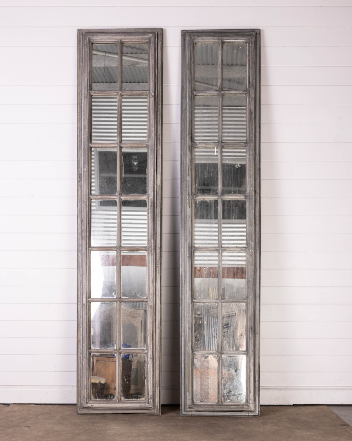 Pair of Oversized tall mirrored panels with grey painted patina frames