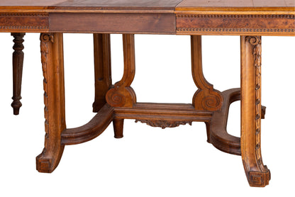 Antique French oak extendable dining table with intricate carvings and detailed stretcher base from Provence