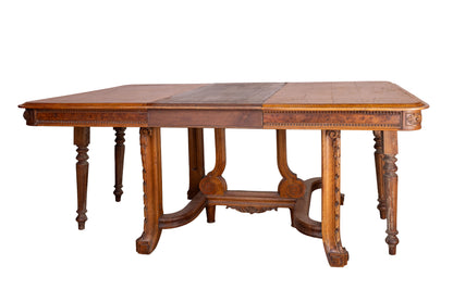 Antique French oak extendable dining table with intricate carvings and detailed stretcher base from Provence