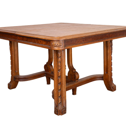 Antique French oak extendable dining table with intricate carvings and detailed stretcher base from Provence