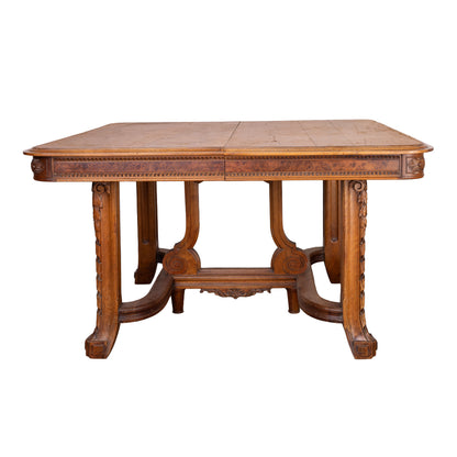 Antique French oak extendable dining table with intricate carvings and detailed stretcher base from Provence