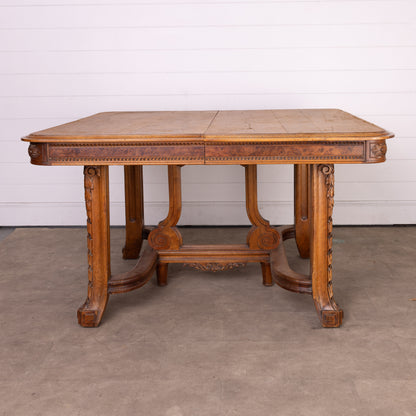 Antique French oak extendable dining table with intricate carvings and detailed stretcher base from Provence