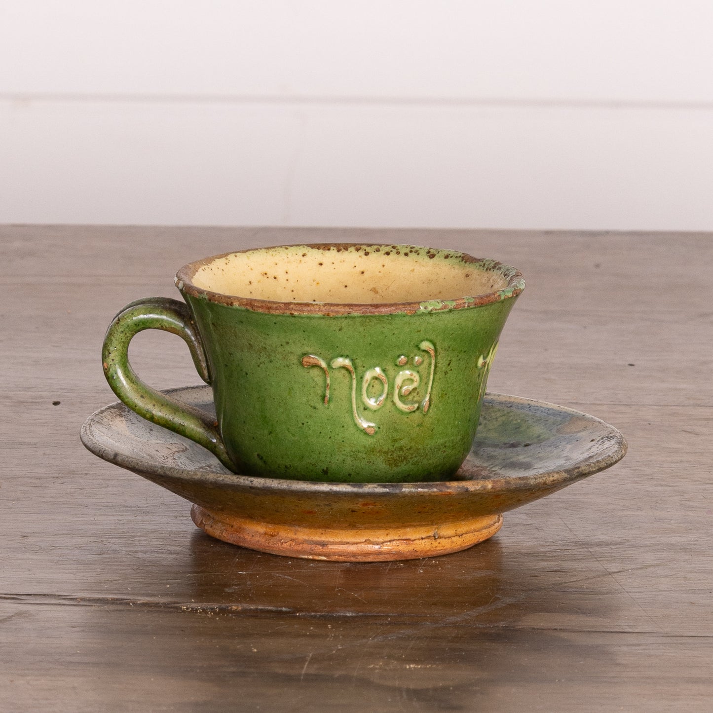 Charming Vintage French Artisan made teacup and saucer in a green and yellow glaze inscribed 'Noel' from Provence