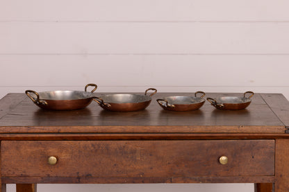 Set of 4 stackable shallow copper serving pans with brass handles from Provence