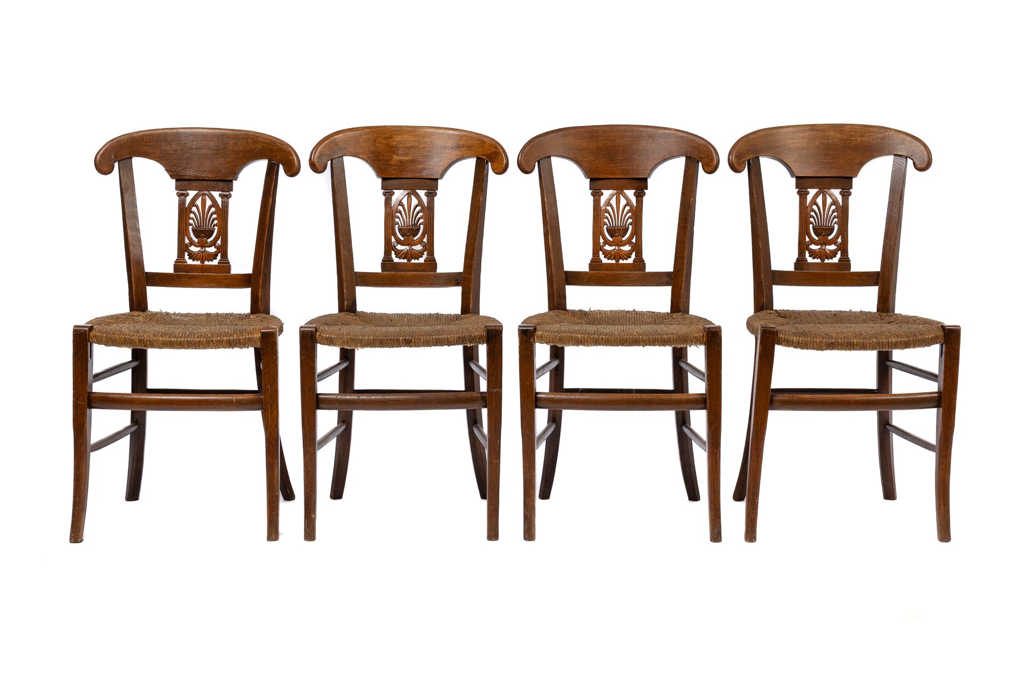 Set of 4 19th century antique French chairs with detailed carvings and rush seats.