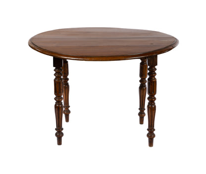 Classic 19th century antique French walnut table with turned legs and fold down sides. Discovered in The French Alps