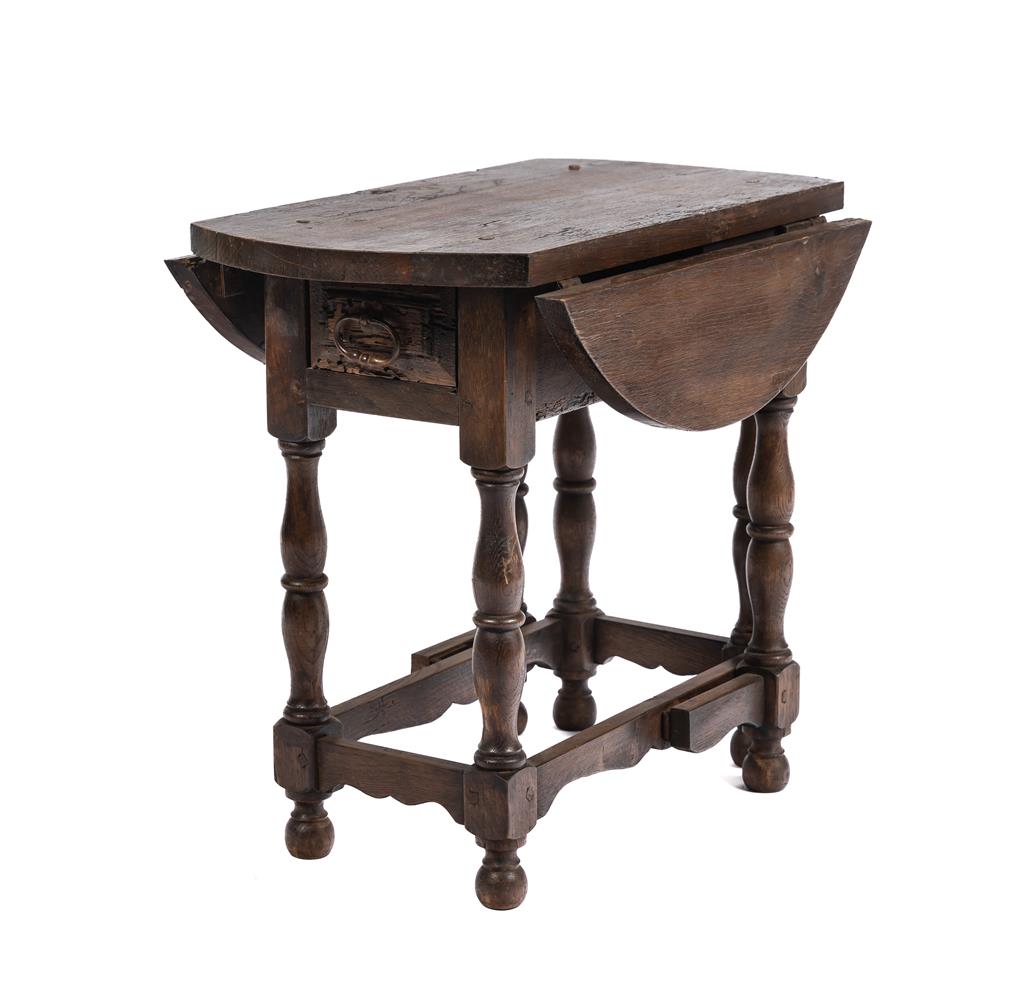 A unique and beautiful small Savoyard side table with fold down sides and legs and central draw with original handle.