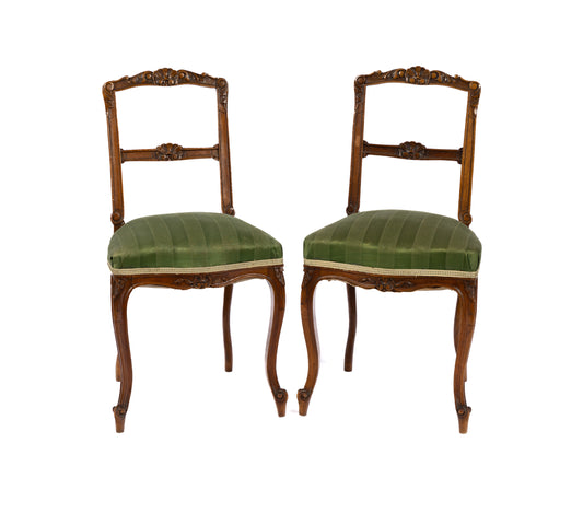 Lovely 19th century antique French walnut side chairs with hand timber carvings and green upholstered fabric. Discovered in The French Alps.