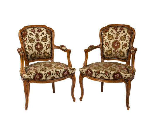 Pair of 20th century antique French walnut armchairs with floral upholstery in excellent condition. Discovered in Provence